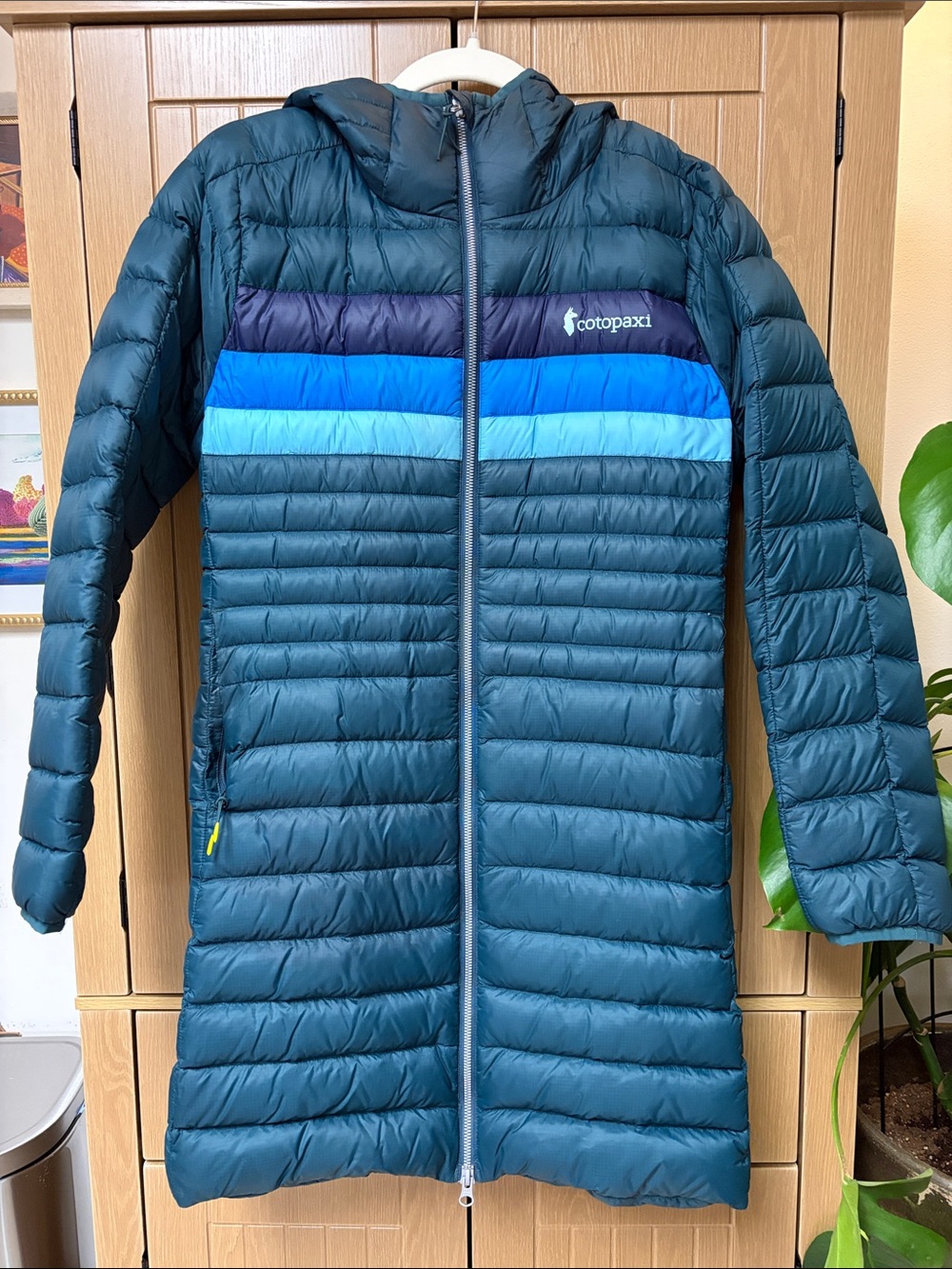Cotopaxi Women’s Fuego Parka with navy, teal and blue stripes